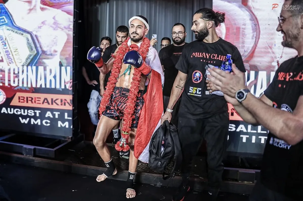 Fight-night support walking out with a combat athlete